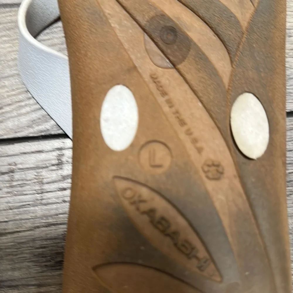Okabashi flip flops with white straps and neutral color bottoms